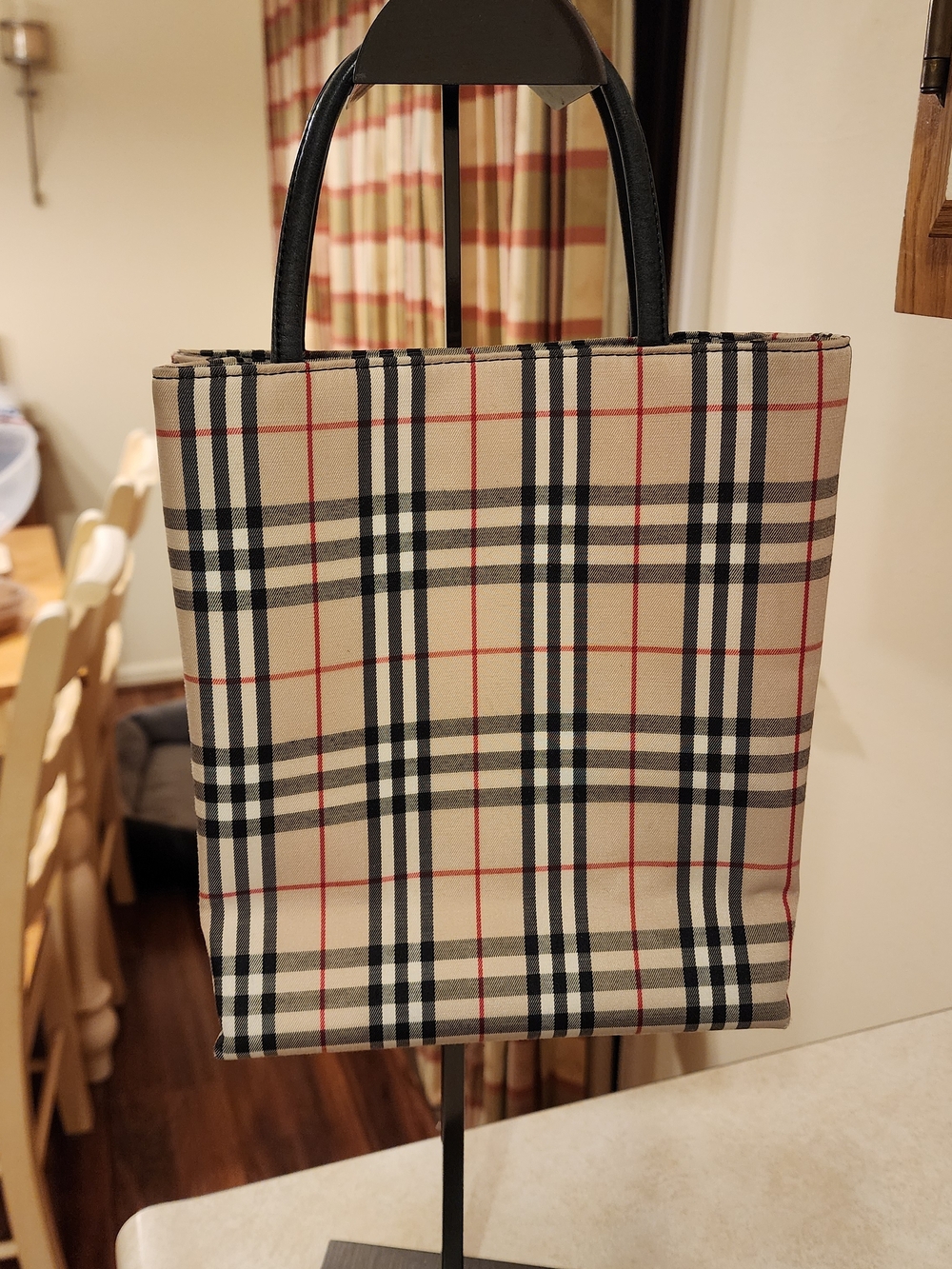 Burberry tote bag featuring the iconic Nova Check pattern black leather handles